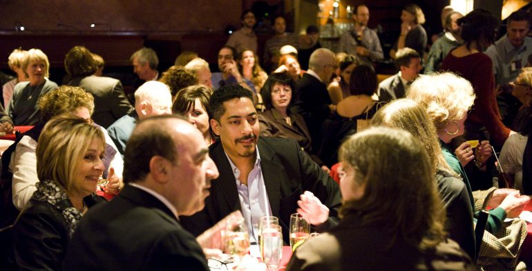 Attendees at dinner tables with drinks
