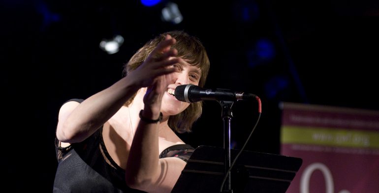 Woman on stage clapping