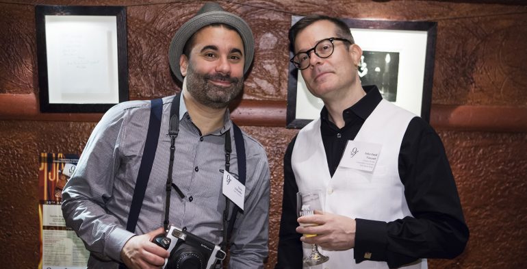 Two men smiling at the camera