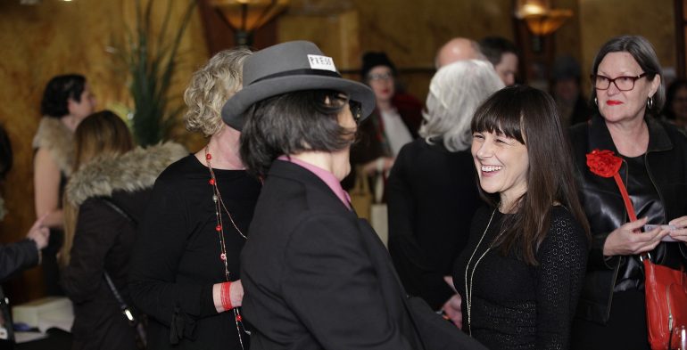 A group of women laughing in passing
