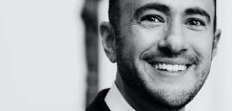 Black and white photo of Josh Levy wearing a bow tie