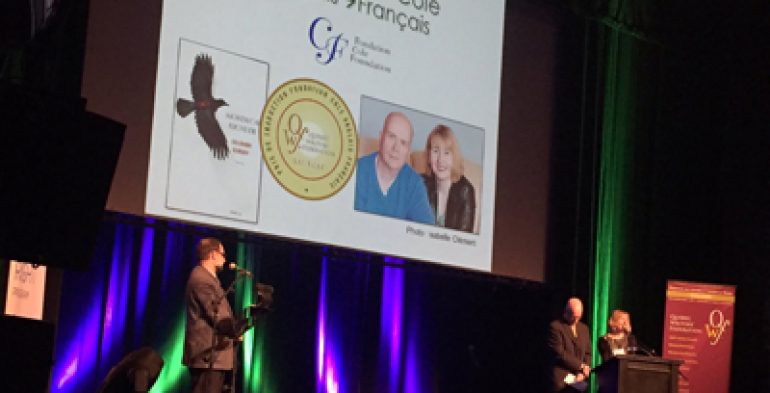 A duo receiving an award on stage