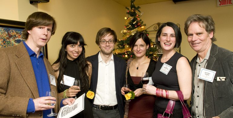 A group of folks holding wine glasses