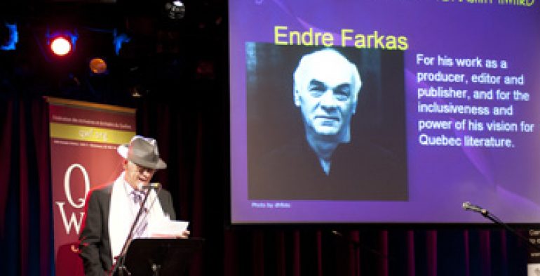 Man wearing fedora reading into a microphone