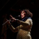 Woman speaks passionately into microphone