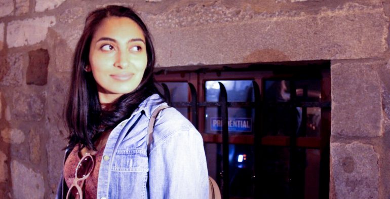 young woman looks over her shoulder into the light